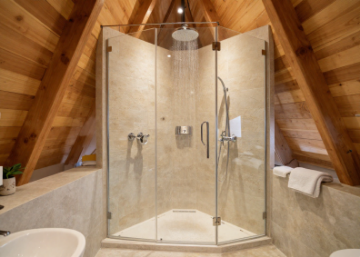 Projected bathroom — rain shower, stone tile, and warm timber